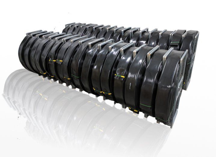 Rows of black tire treads stacked in a neat line on a white background