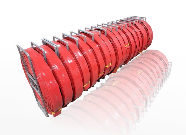 Red stack of coiled metal hose reels arranged in a row on a white background