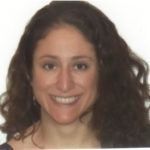 Smiling woman with long curly dark hair against a plain white background