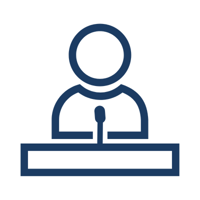 Blue icon of a person speaking at a podium with a microphone