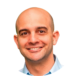 Smiling bald man in a light blue shirt on a white background