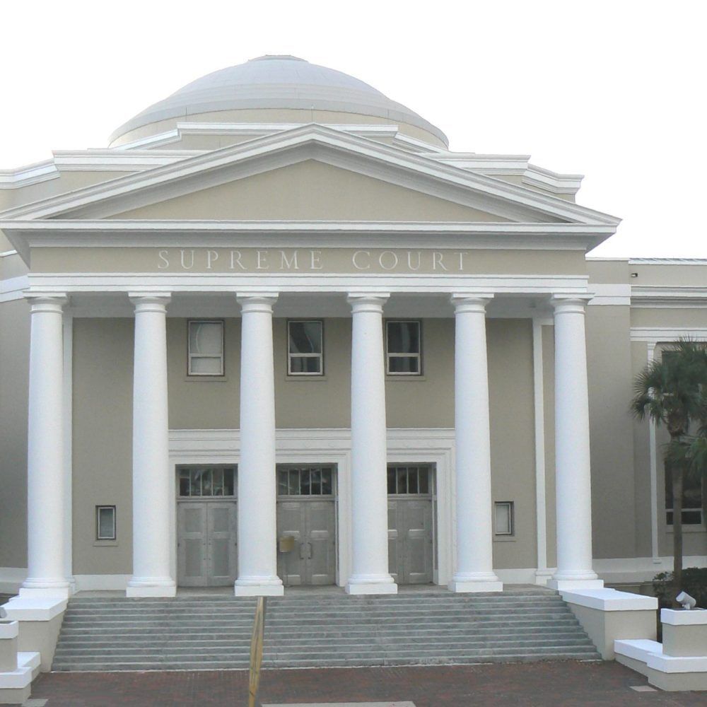 Classical building facade with white columns, dome, and broad steps
