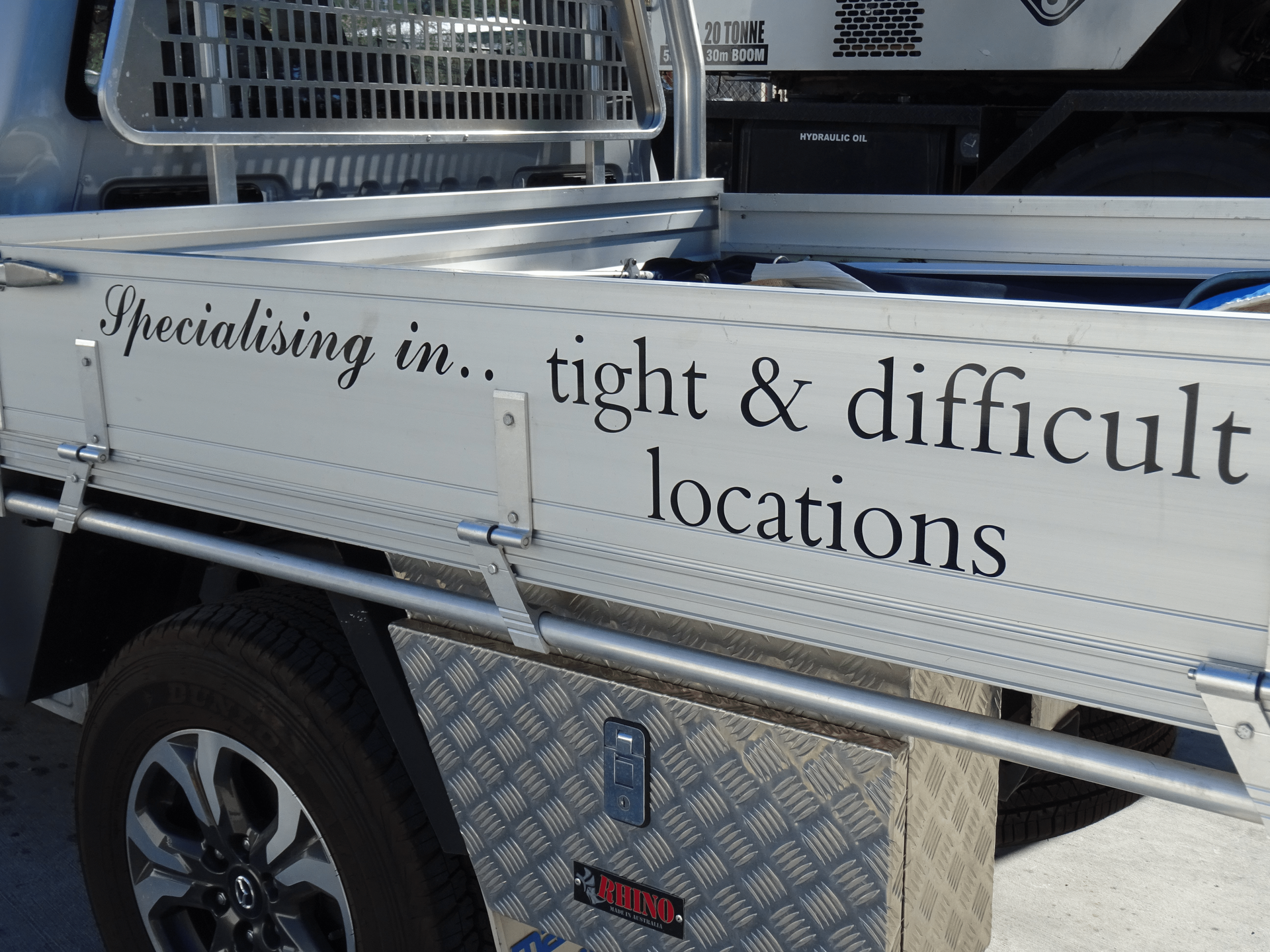 Truck side panel with text “Specialising in… tight & difficult locations”