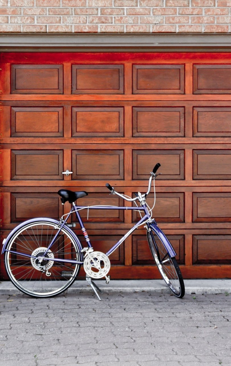 Redwood finished garage door wick bike parked in front