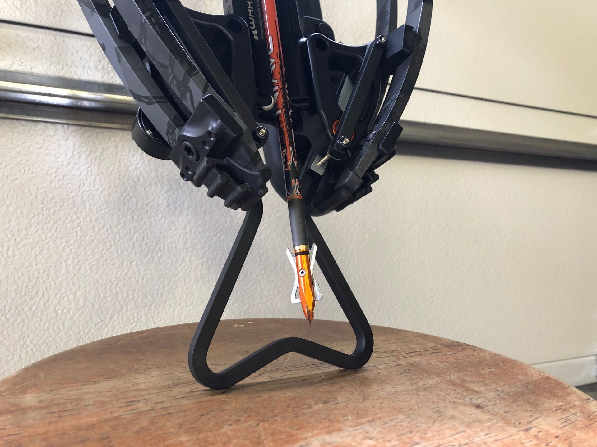 A crossbow with a heart shaped handle on it
