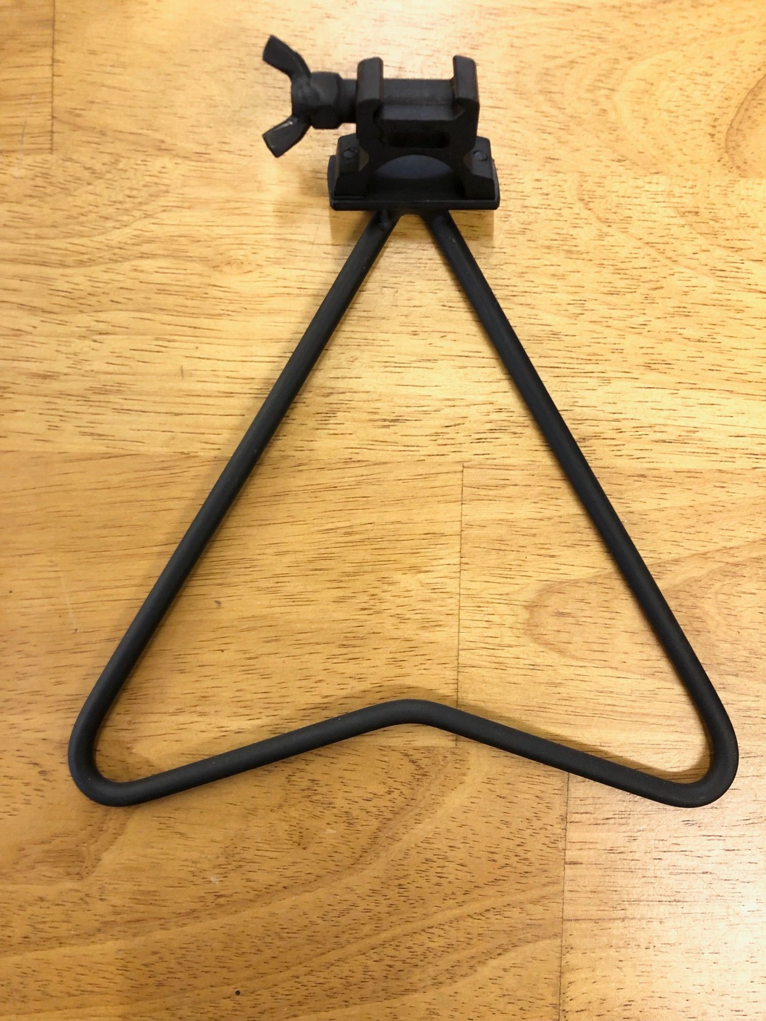 A black metal object is sitting on a wooden table.