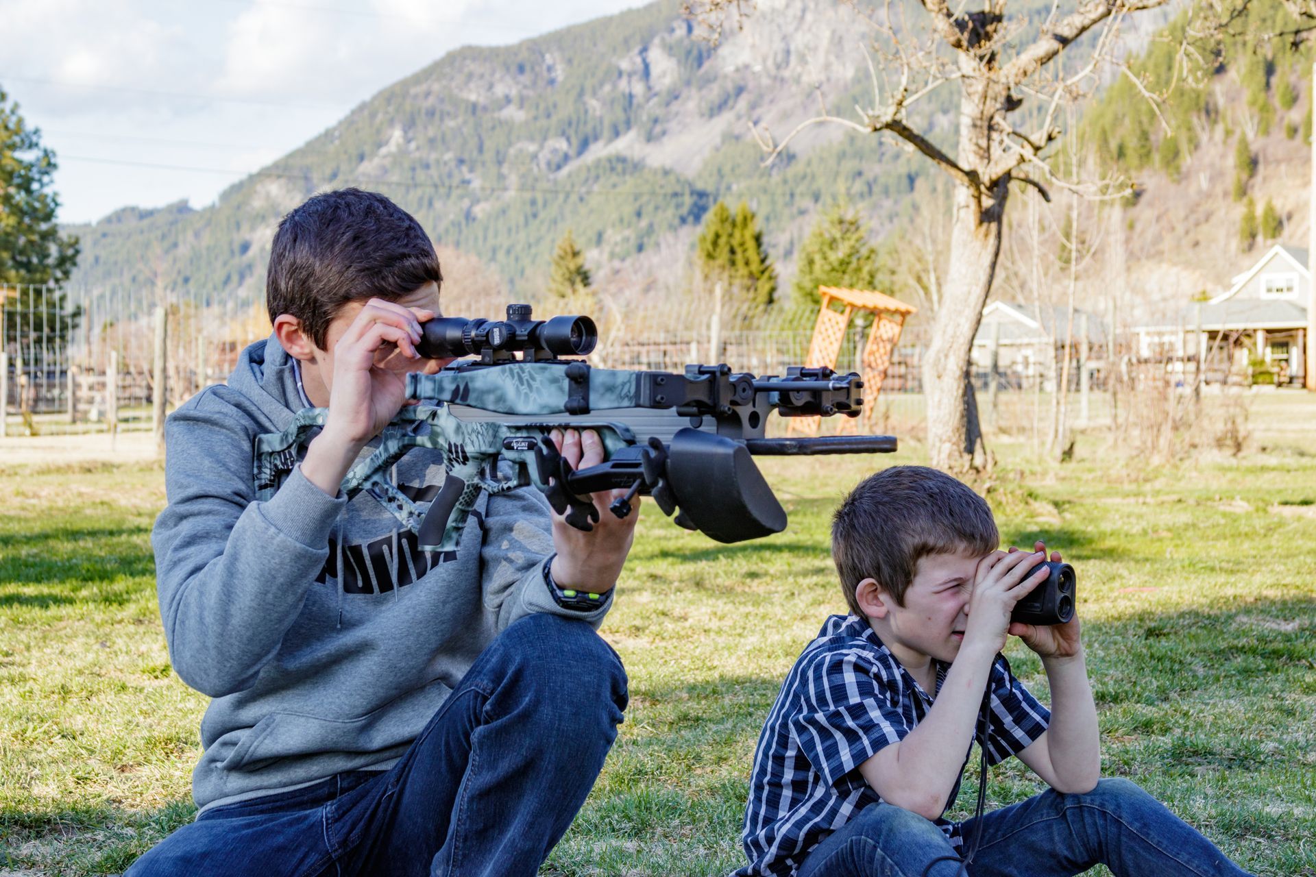 Boys hunting with crossbows and using range finders. 