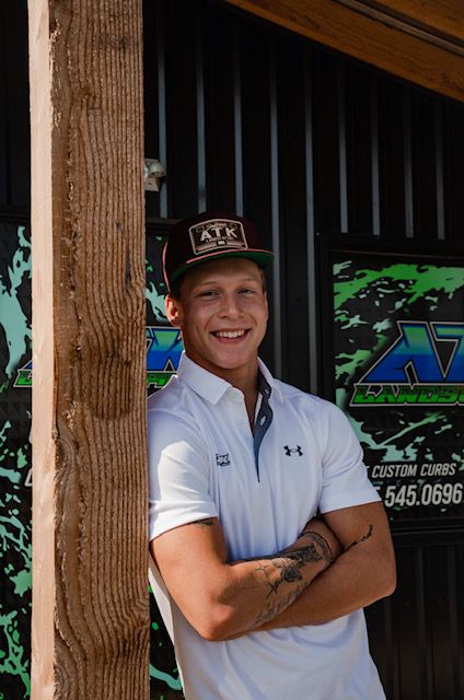 A man in a hoodie is sitting on a chair in a room.