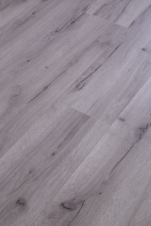 A close up of a gray wooden floor in a room.