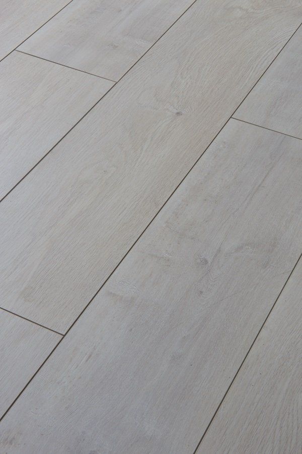 A close up of a white wooden floor with a few lines on it.