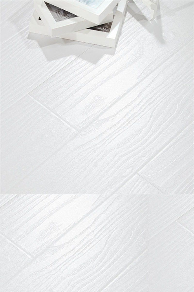 A stack of books sitting on top of a white wooden floor.