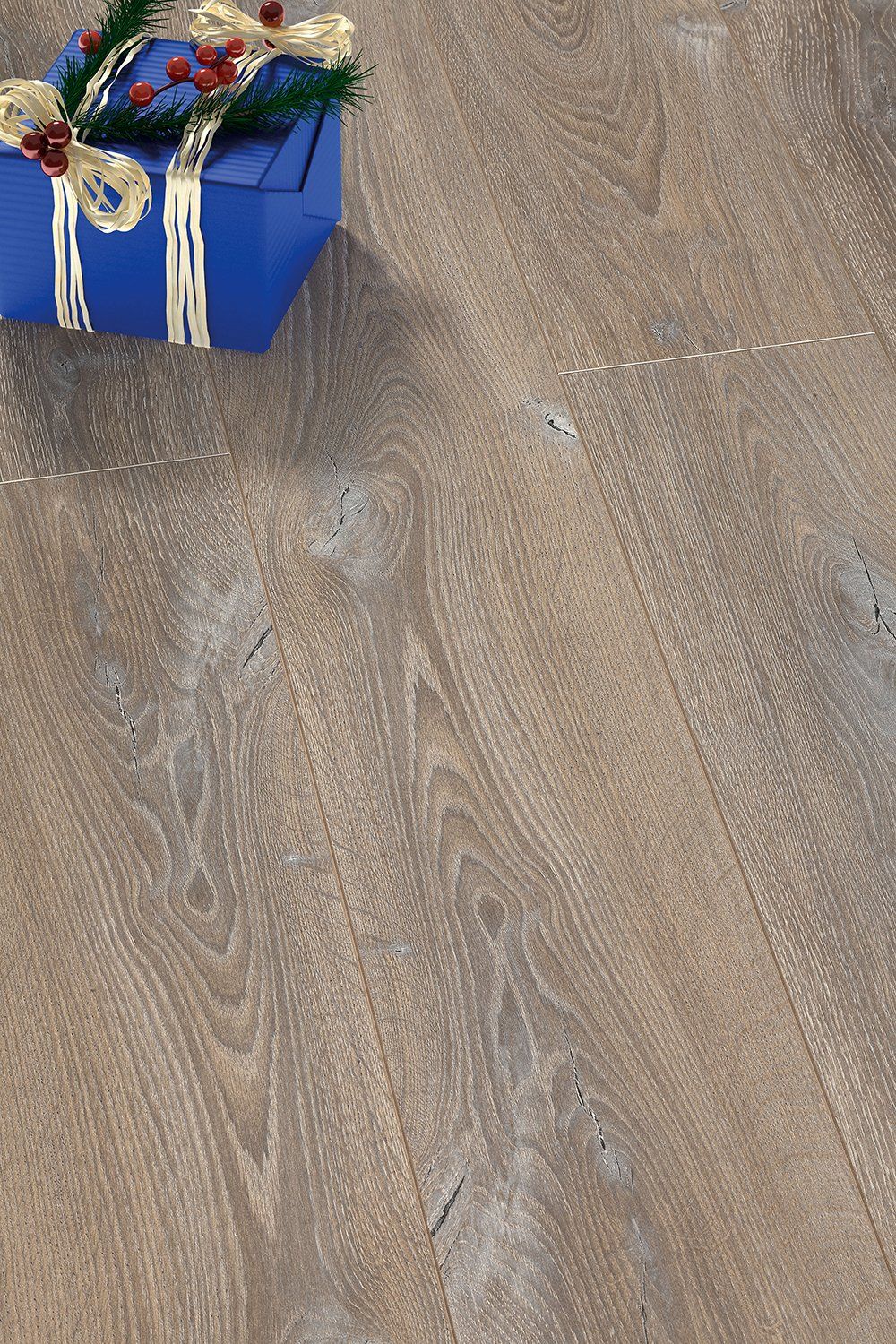 A blue gift box is sitting on a wooden floor.
