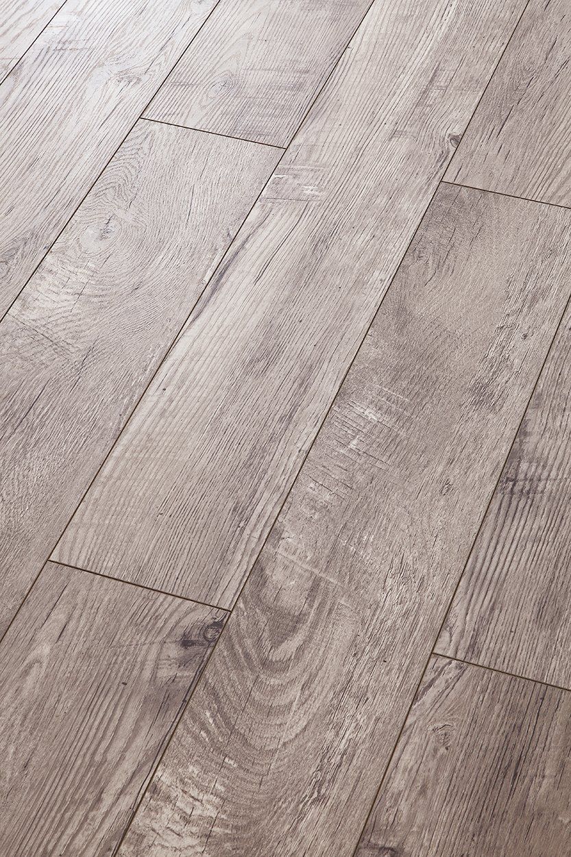 A close up of a wooden floor in a room.