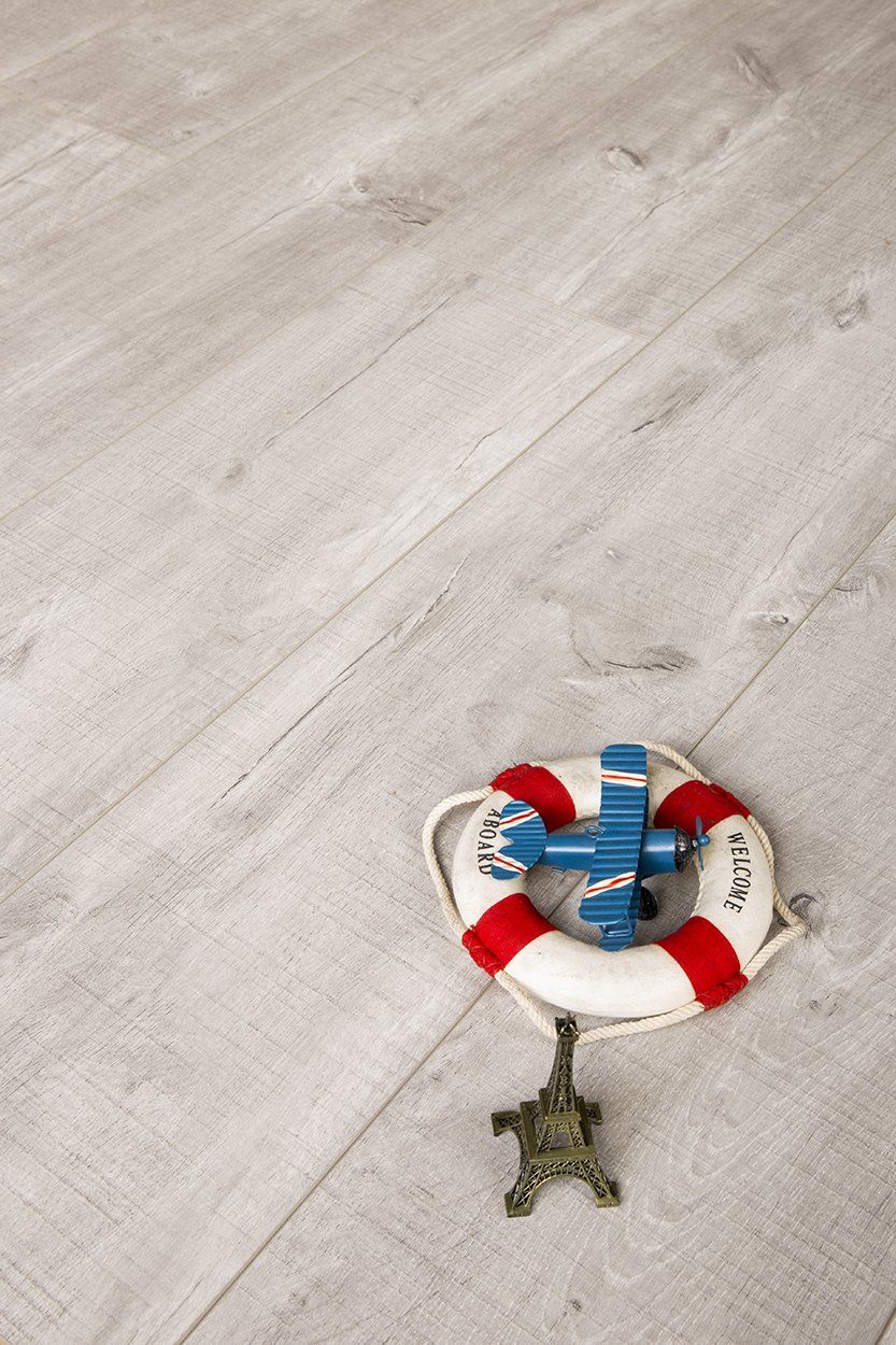 A life preserver and a toy airplane are on a wooden floor.