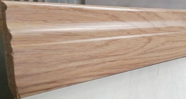 A close up of a piece of wood with a saw cutting it.