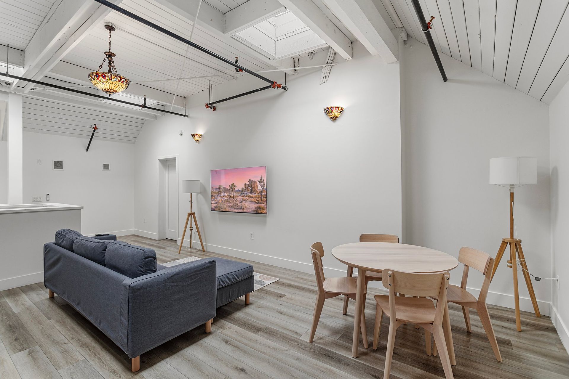 Furnished loft living room and dining area at Oasis on Orchard apartments near USC