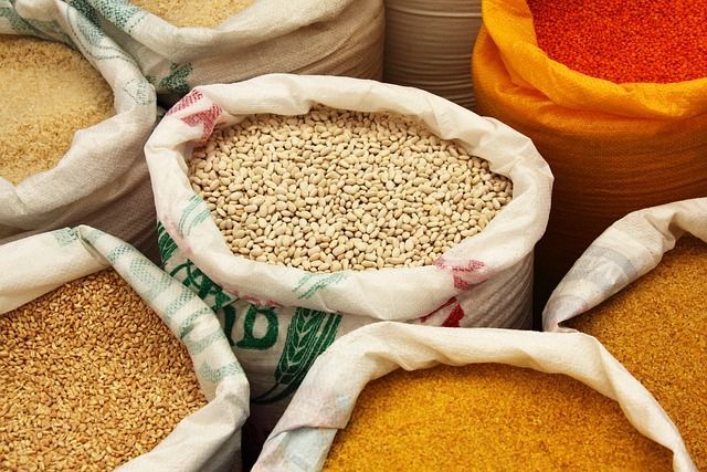 Bags overflowing with various grains, including rice, beans, and lentils.