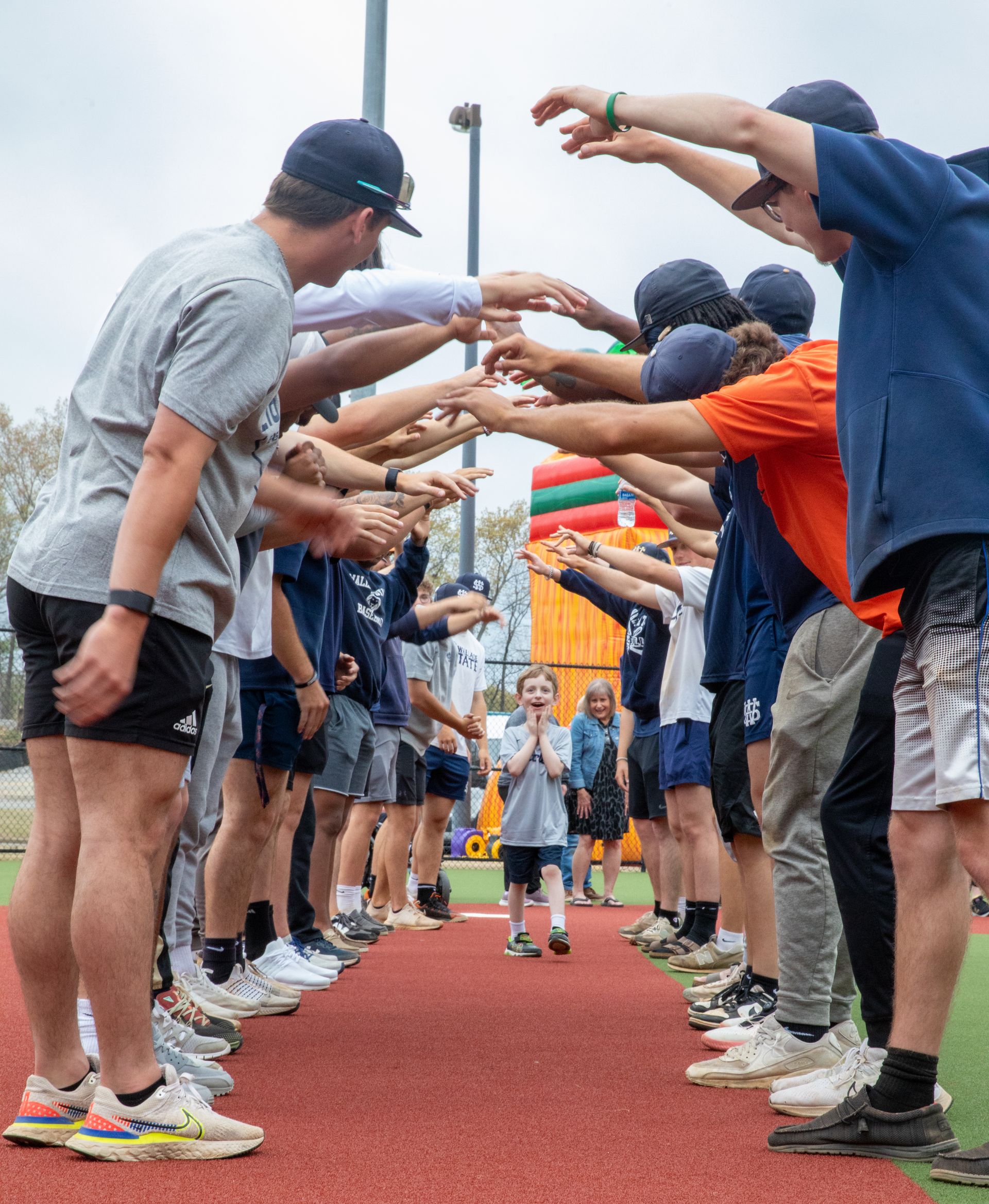 A group of people are standing next to each other on a track.