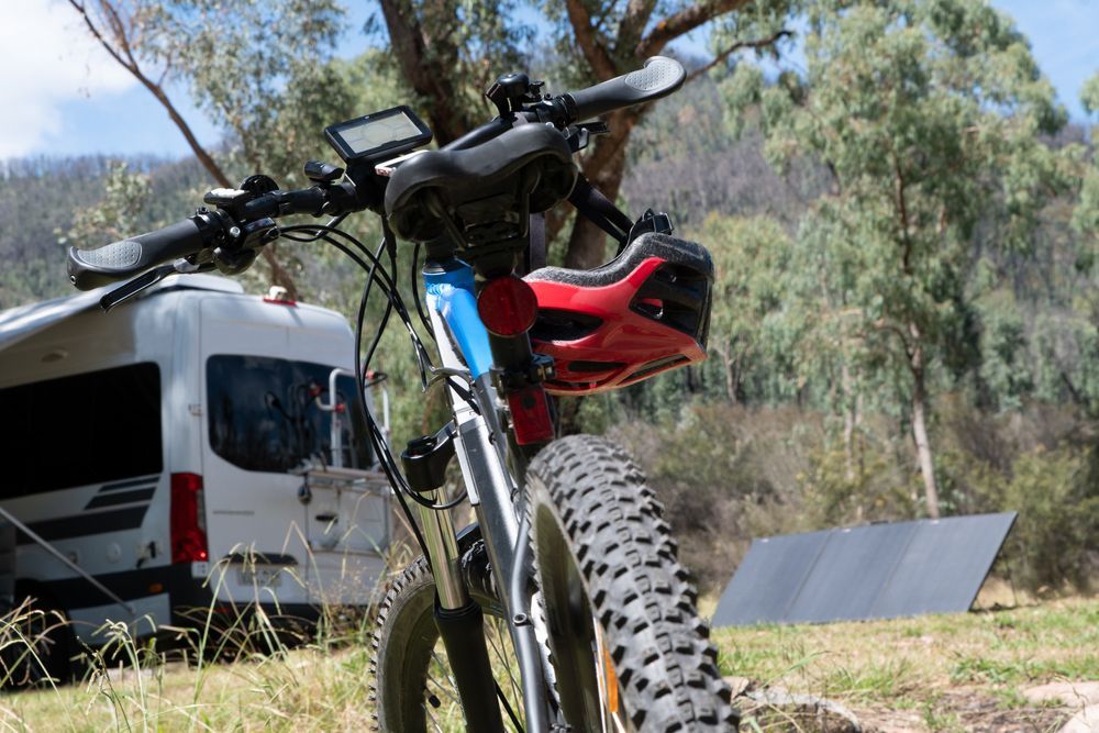 a bicycle is parked in front of a white van