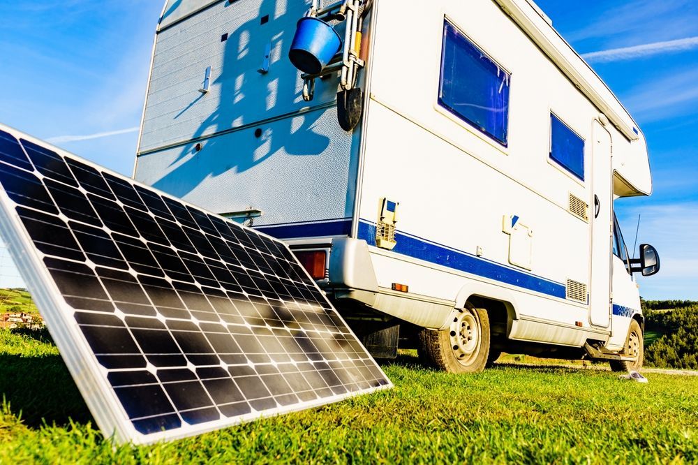 a row of solar panels with trees
