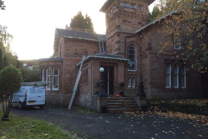 Roofers Kilmarnock setting up ladders for a roof repair in Galston