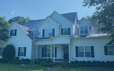 White two-story suburban house with black shutters, front porch, and a ladder leaning against it