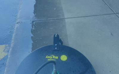 Blue-tinted view of a concrete sidewalk with a circular black object at the bottom edge