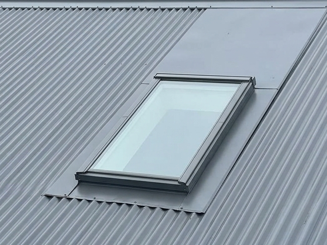 Rooftop skylight on a gray corrugated metal roof