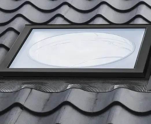 Black-framed skylight on a gray corrugated metal roof