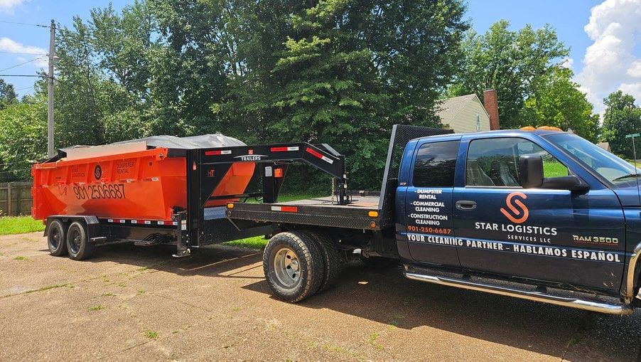 A blue flatbed truck parked outdoors, hitched to an orange dump trailer with Star Logistics branding on the door.