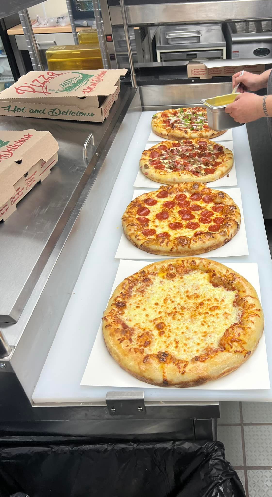 Three Pizzas from Lara's Market lined up for orders.