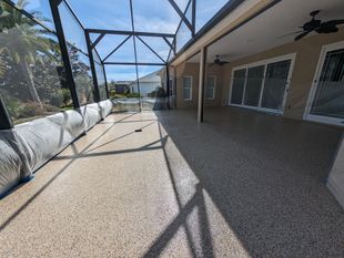 Screened patio walkway beside house with gravel floor and sunlight shadows