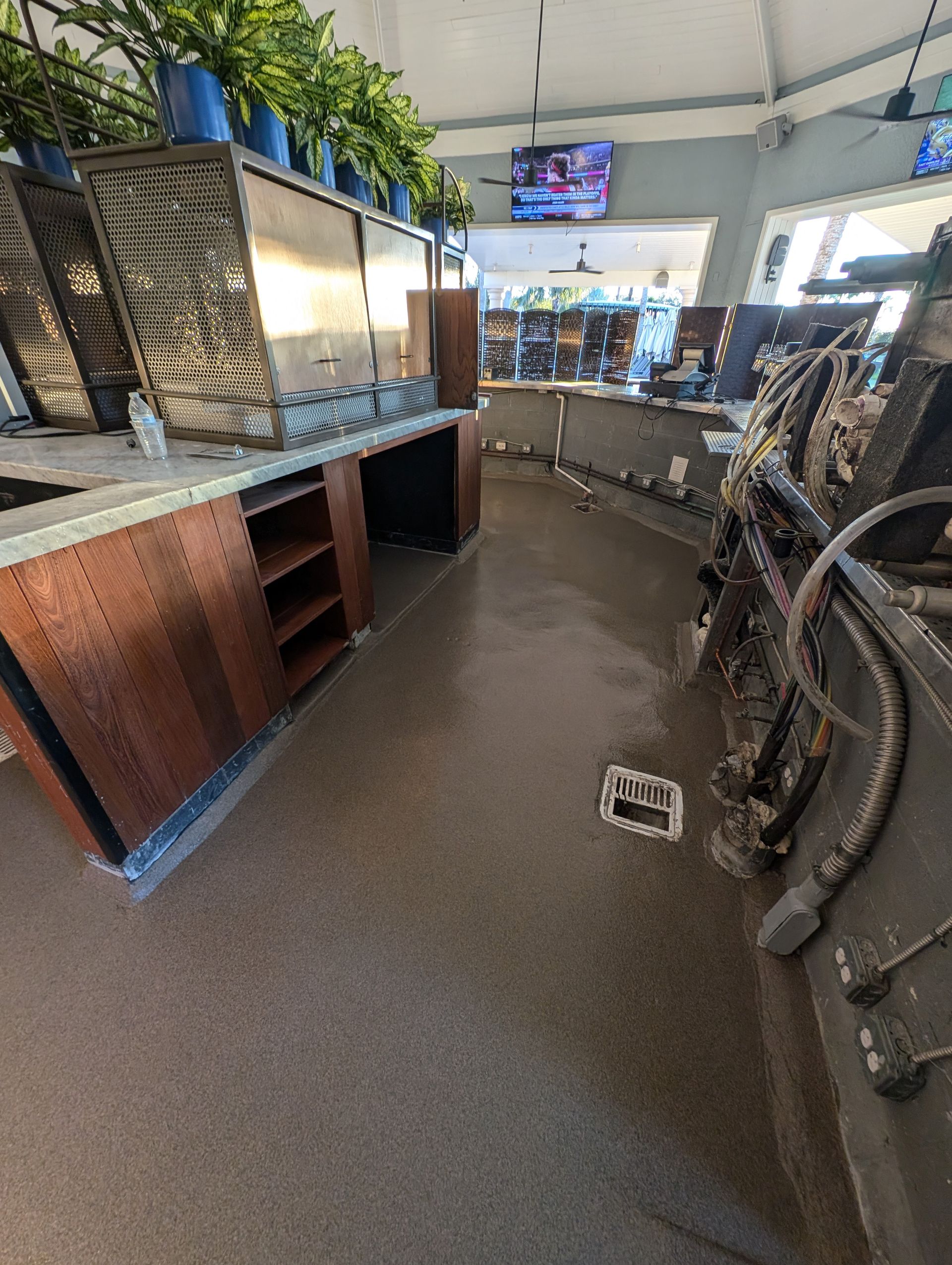 Bike shop interior with bicycle wheels, display cases, and a TV overhead