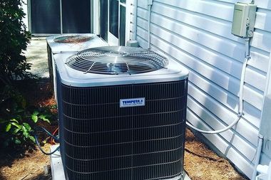 Two Tempstar air conditioning units installed outdoors next to a house with light-colored siding.