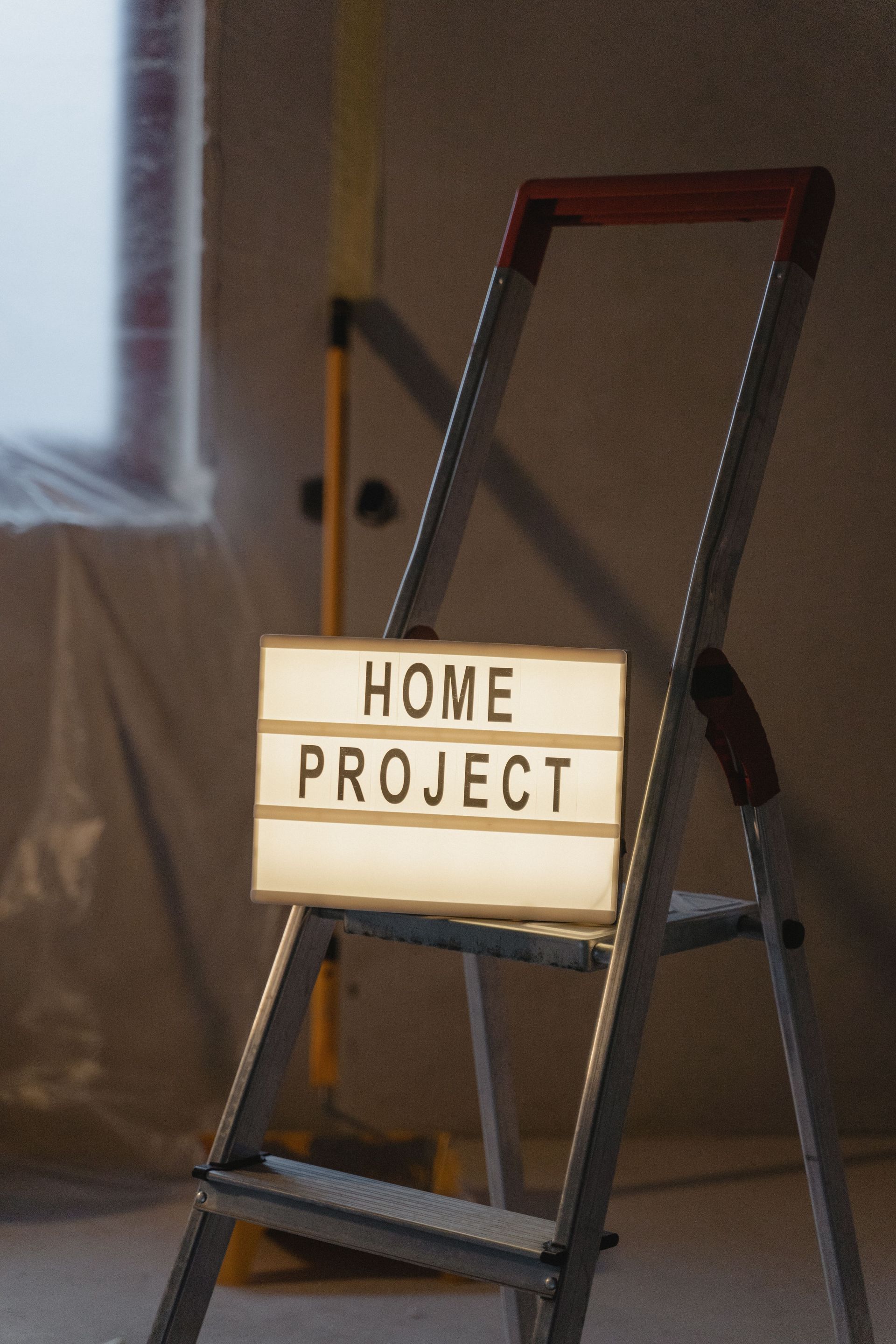 Home project sign on a ladder in a room under renovation