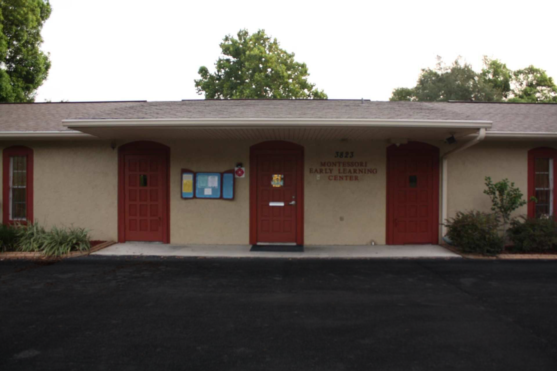 Building With Red Doors and a Bulletin Board on the Front