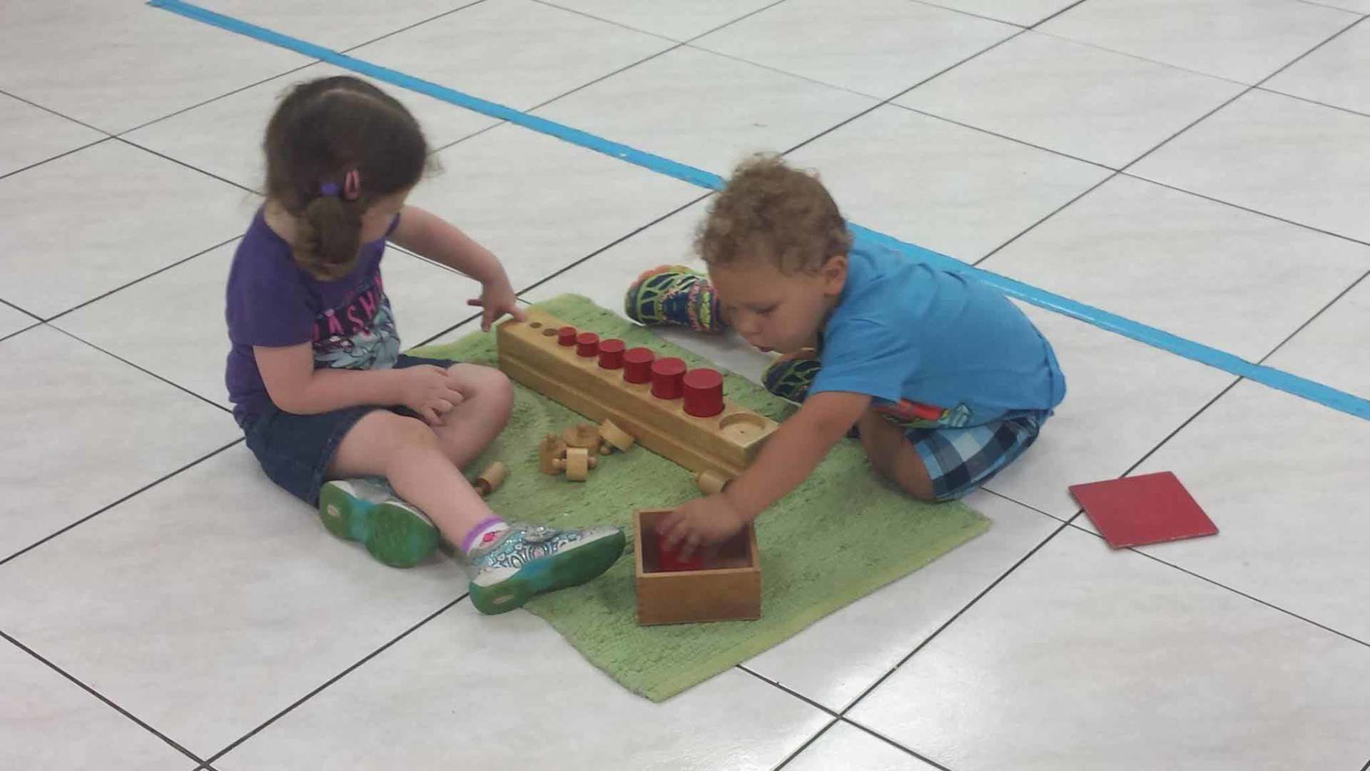 Boy and a Girl Are Playing With Toys on the Floor