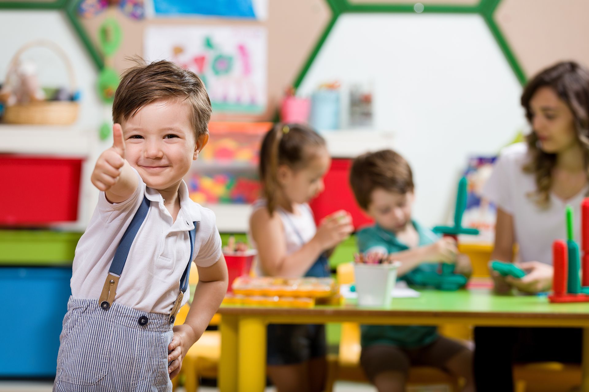 Young Boy is Giving a Thumbs Up in a Classroom