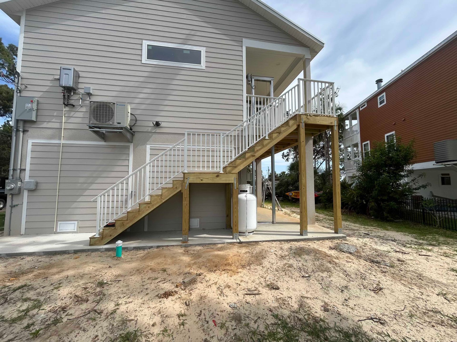 Covered outdoor screen enclosure with cement floor and RV parking area
