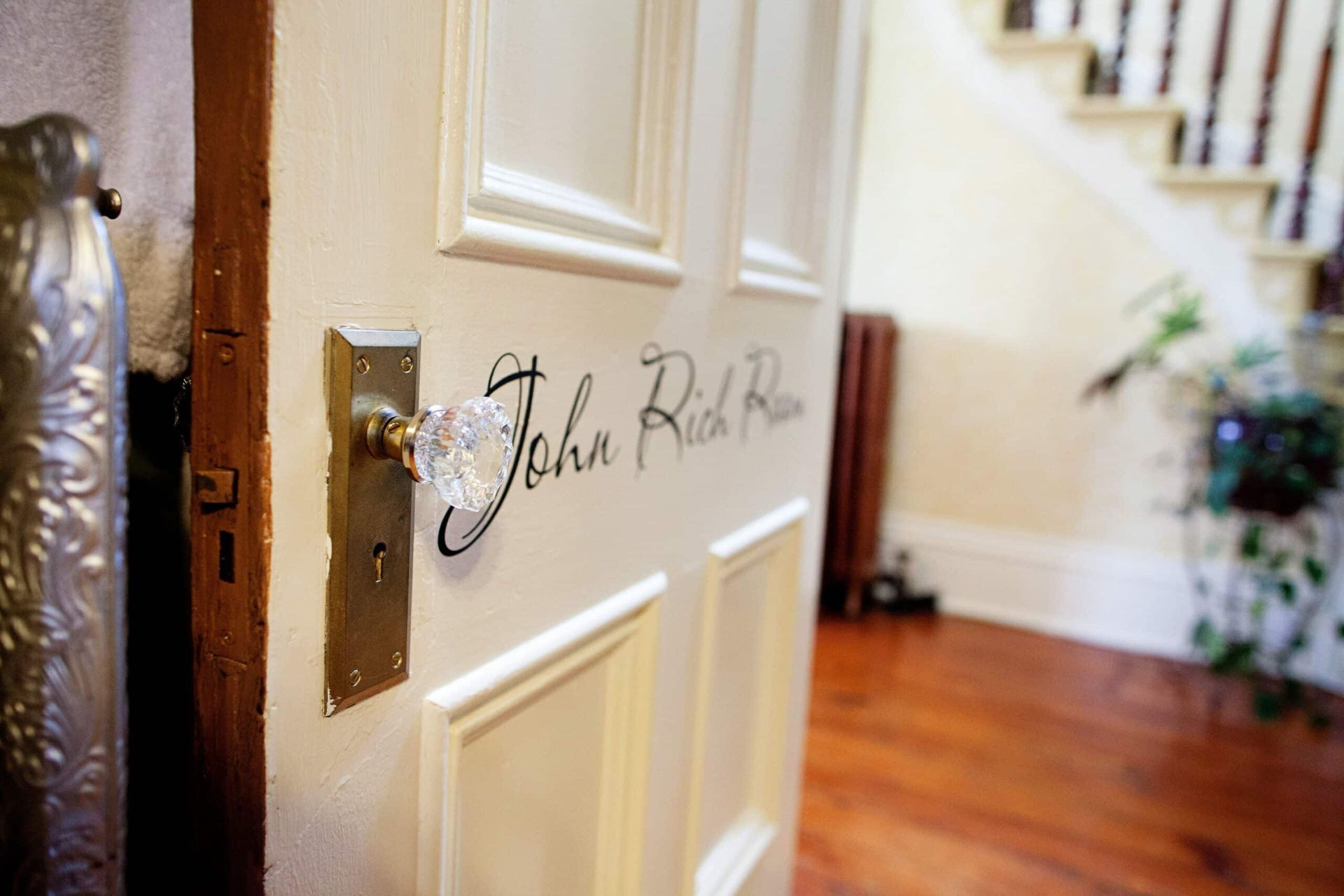 A white door with the name john written on it.
