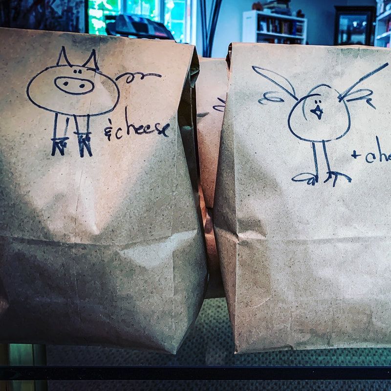 Two brown paper bags, each featuring a hand-drawn animal—a pig on the left and a bird on the right—labeled 