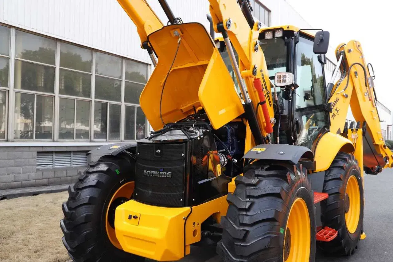 Yellow and black backhoe loader parked outside a building. Hood is open, revealing engine components.