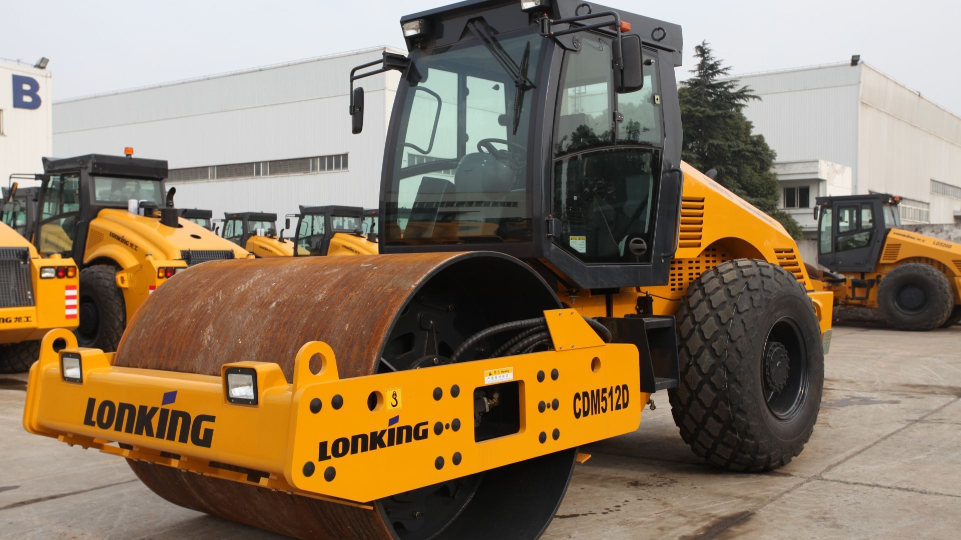 Yellow Lonking road roller in a construction yard.
