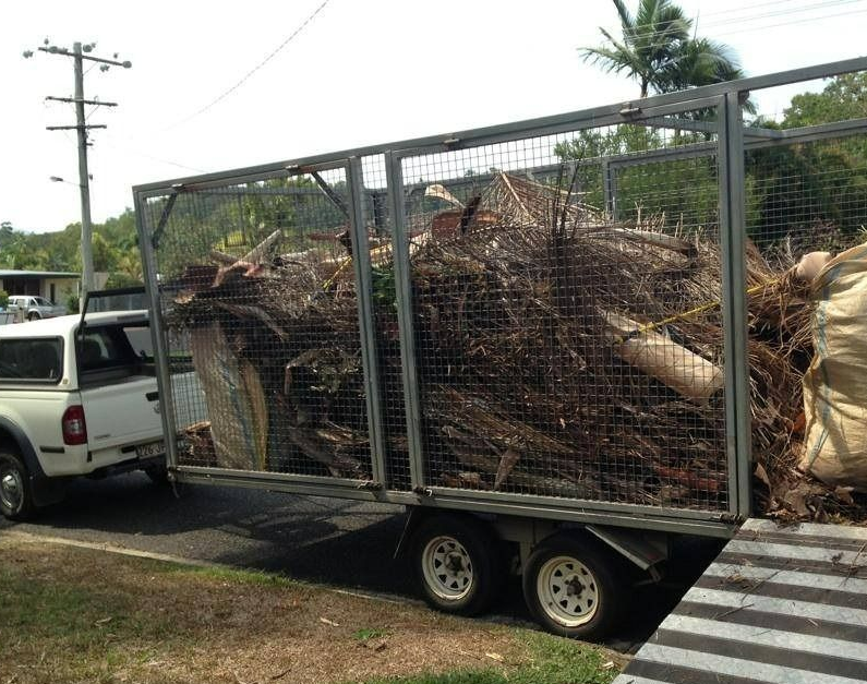 White Truck Towing a Trailer Overflowing With Yard Waste — All Suburbs Garden Bags in Palm Cove, QLD