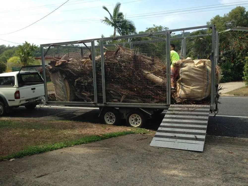 Truck Pulling a Trailer Loaded With Branches and Debris — All Suburbs Garden Bags in Gordonvale, QLD