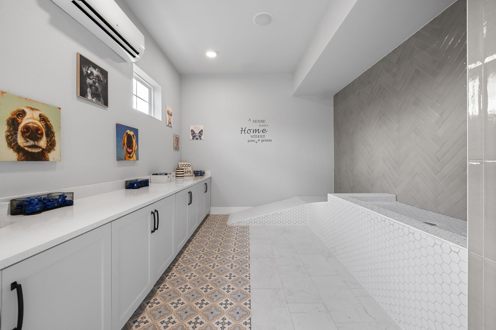 Dog grooming room with light gray cabinetry, wall art, and a tiled bathing area at The Wyatt, offering Cedar Park luxury apartments.