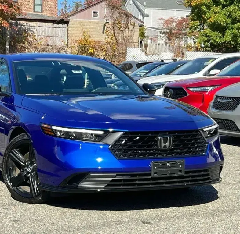 Blue Honda SUV parked in a lot, front view, with red and white cars behind it. | Dillsboro Automotive
