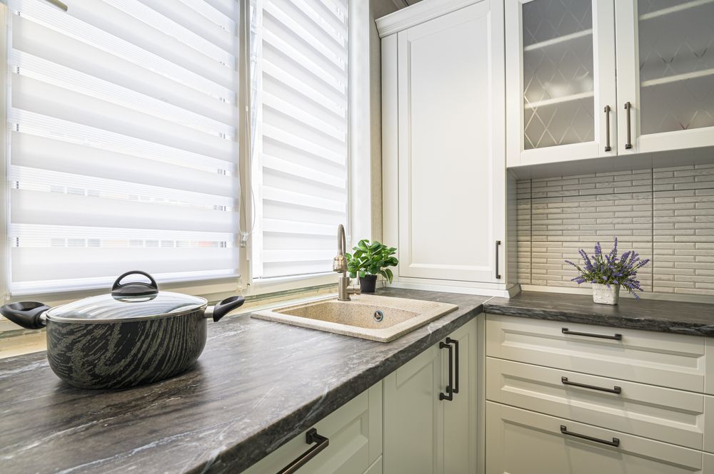 Kitchen With White Cabinets, Dark Countertop, and Sink — Verastone In Fyshwick, ACT