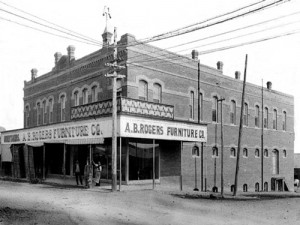 Black-and-white photo of A.B. Rogers Furniture Co. storefront on a corner street.
