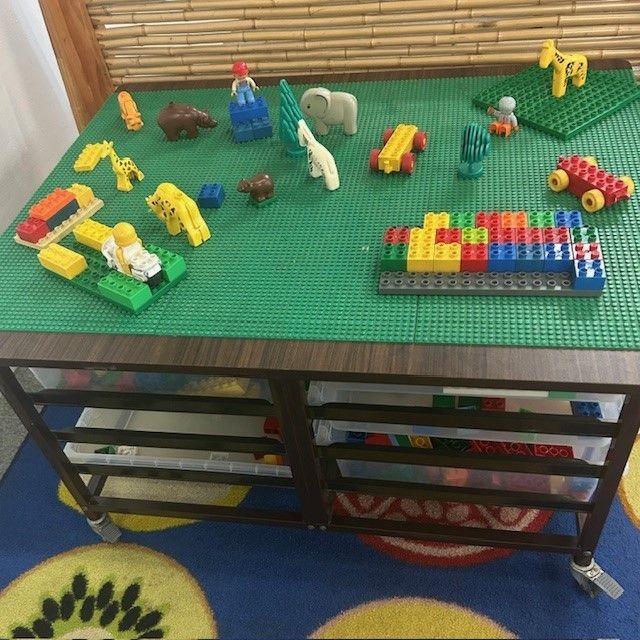 A Boy and a Girl Are Laying on the Floor Playing With Colorful Blocks โ Birralee Child Care Centre Assn Inc In Mackay, QLD
